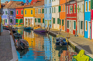 Colorful buildings along a canal in Burano, Italy.