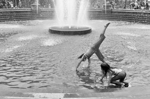 Girls playing in a fountain in Washington Square Park in New York City.