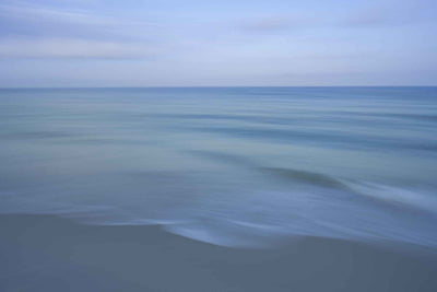 Dreamy abstract beach photo with gentle waves.