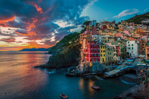 Riomaggiore in Cinque Terre, Italy at sunset with colors in the sky.