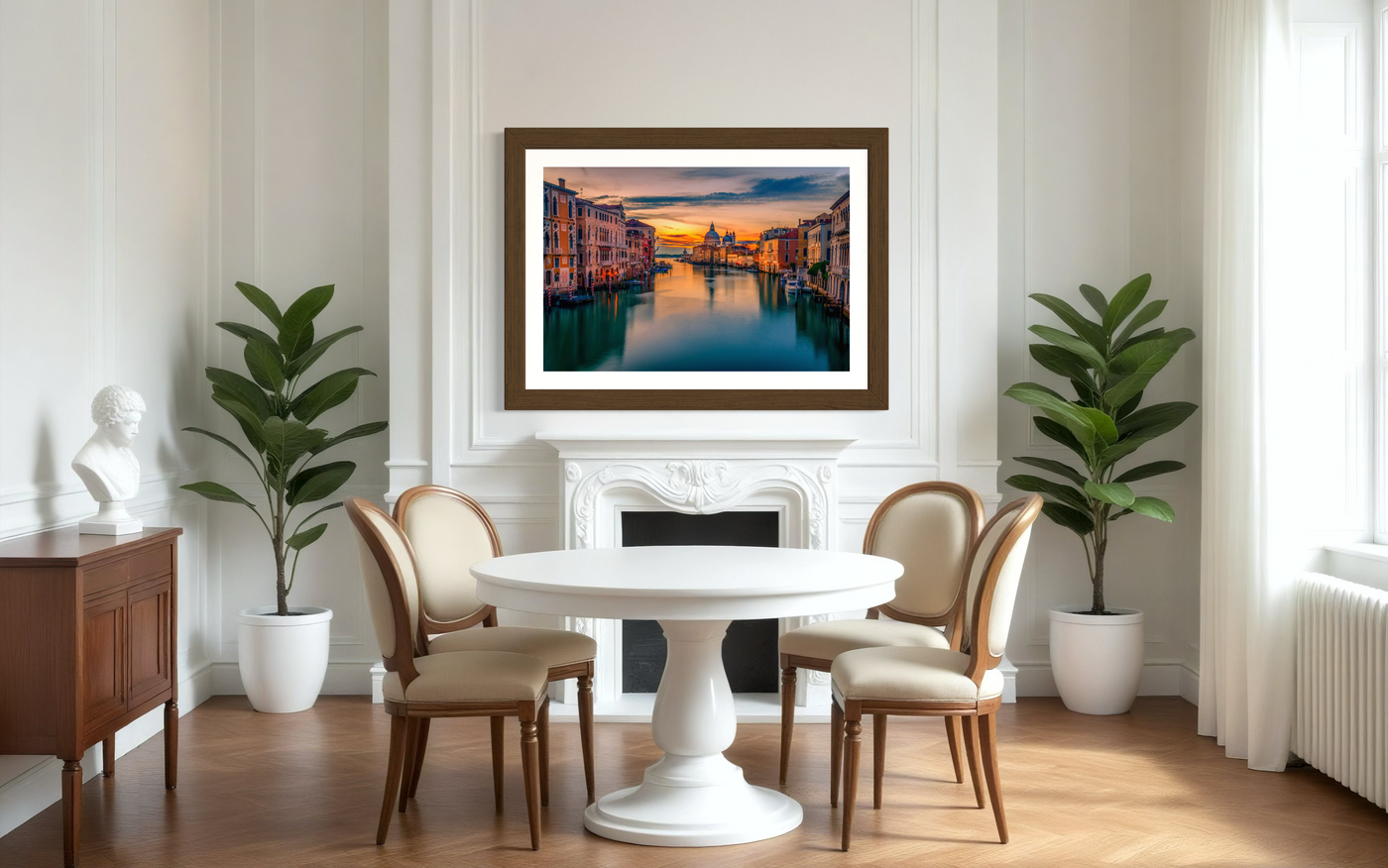 The Grand Canal in Venice at sunrise with a stillness in the water and hues of orange and yellow in the sky.